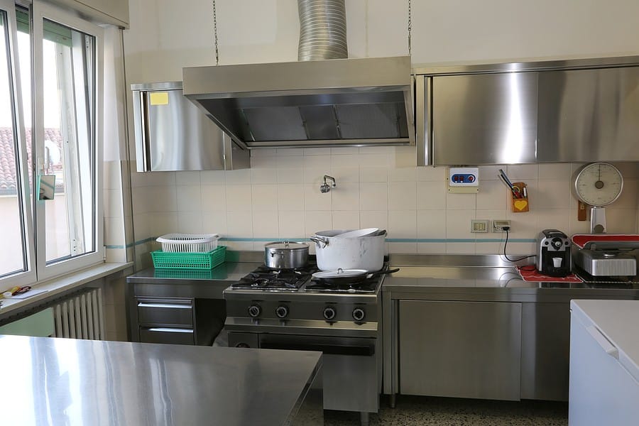 kitchen with furniture in stain steel and many kitchenware